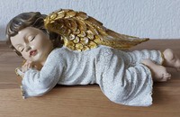 Schlafender Engel mit gold- und silberfarbigen Flügeln